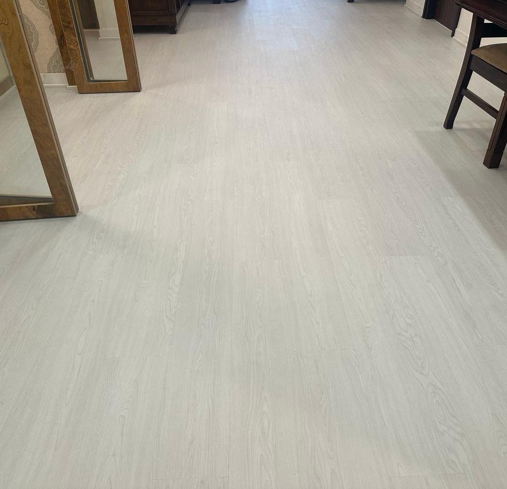 Main hall installed with Ivory Oak SPC on existing marble in Bangalore since the old marble was slippery for Old Aged People.